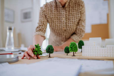 Close-up of woman architect with model of houses in officeの写真素材