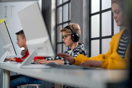 School kids using computer in classroom at school