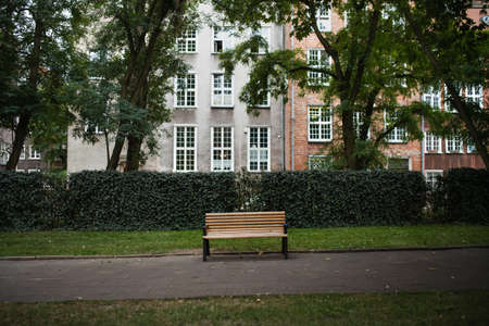 Wooden empty bench in hisotric town park.の写真素材