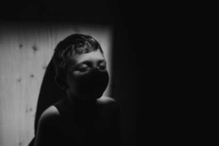 Black and white portrait of sad anonymous little boyの写真素材