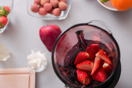 Raw strawberries in blender ready to make fresh homemade smoothie. Healthy lifestyle conceptの写真素材