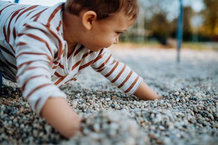 A little boy playing on outdoor playground.の写真素材