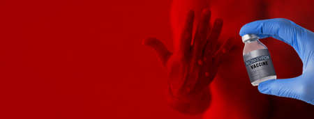 Doctors hand holding monkeypox vaccine with male hand affected by blistering rash because of...