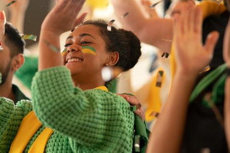 Brazilian young football fans supporting their team at stadium.