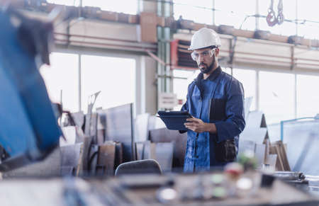 Engineering manager doing routine check up in industrial factoryの写真素材