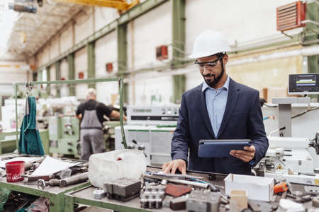 Engineering manager doing routine check up in industrial factory