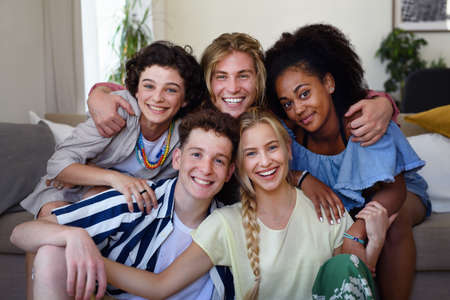 Portrait of diverse group of friends with mixed races having fun together indoors, Friendship and...
