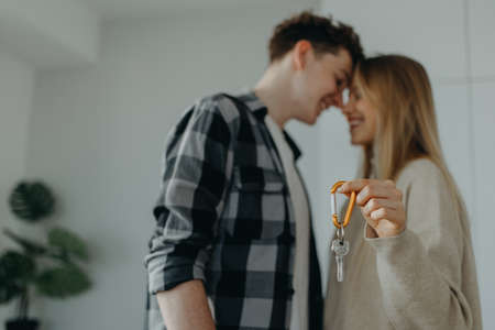 Cheerful young couple in their new apartment. Conception of moving.の写真素材