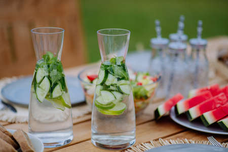 Cold refreshing summer drinks and fruit set on table at garden.の写真素材