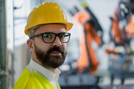 Portrait of male chief engineer in modern industrial factory looking at camera.の写真素材