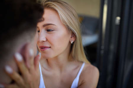 Young couple in love cuddling and kissing outdoors on terrace, weekend away in tiny house in...