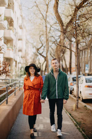 Young couple in love walking outdoors at the city street, huggingの写真素材