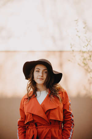 Portrait of beautiful young woman standing in front of city wall.の写真素材