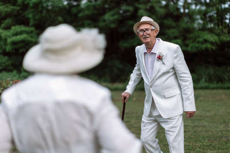 Senior couple having marriage in nature during summer day.の写真素材