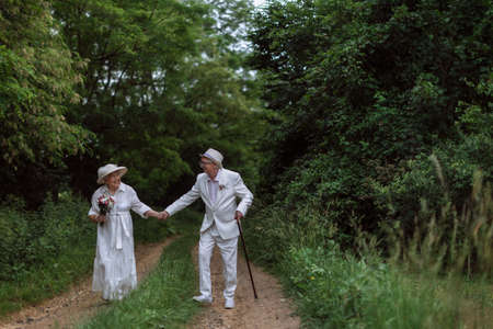 Senior couple having wedding photography in forest during summer day.の写真素材