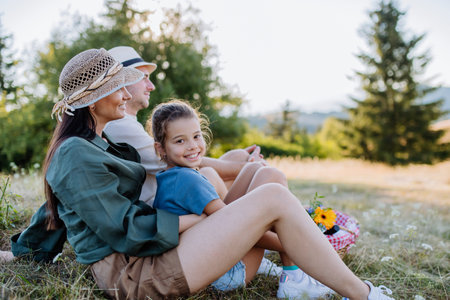 Happy mother and her daughter hugging together during family picnic in nature.の写真素材