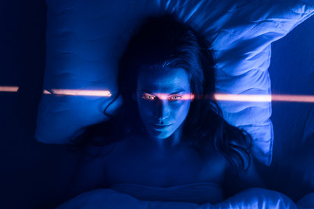 Close-up of lonely woman suffering from insomnia and depression, lying sleepless in bed at night.