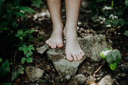 Close-up of barefoot legs walking in forest. Concept of healthy feet.の写真素材