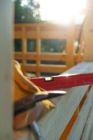 Close up of construction tools inside of unfinished wooden house.