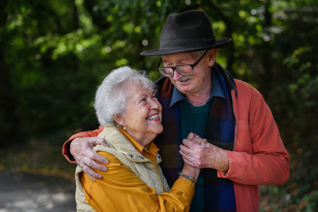 Portrait of senior couple in love at walk in city park.の写真素材