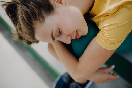 Portrait of young sportive woman resting outdoor in city.の写真素材