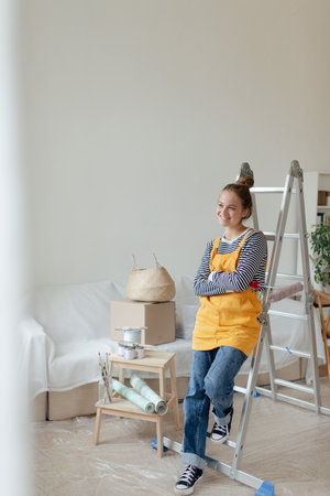 Happy young woman having break during renovation her aparatment.の写真素材