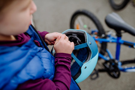 Top view of little boy holding helmet, preparing for bicycling.の写真素材
