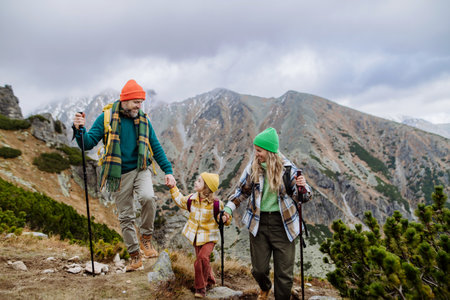 Happy family hiking together in autumn mountains.の写真素材