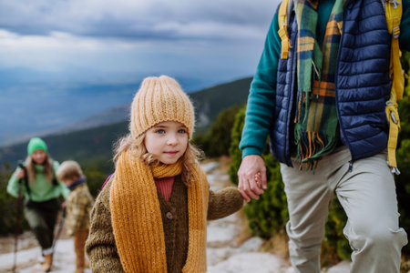 Happy family hiking together in autumn mountains.の写真素材