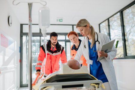 Young woman doctor taking care of patient from rescue ambulance.の写真素材