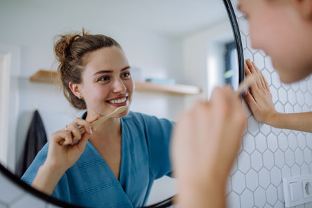 Young woman brushing her teeth, morning routine concept.の写真素材