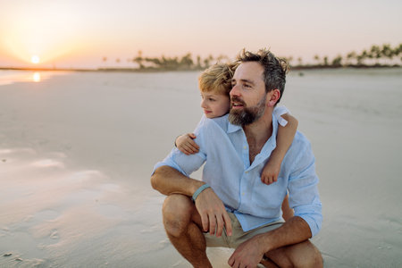 Father with his son enjoying together time at sea.の写真素材