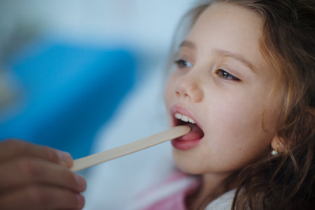 Close-up of examining little girls throat in hospital.の写真素材
