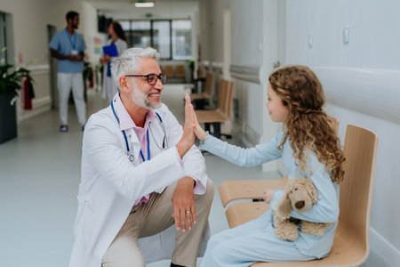 Doctor playing with his little patient at pediatrics.の写真素材