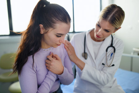 Close-up of doctor consoling unhappy teenage girl in her ambulance office.の写真素材
