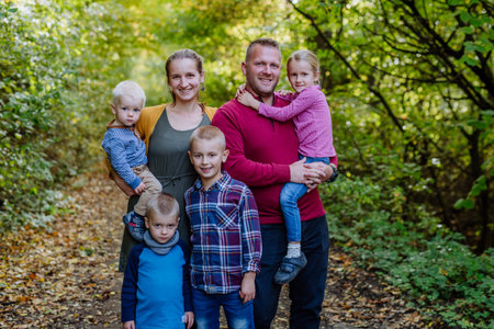 Portrait of happy family with kids in a forest.
