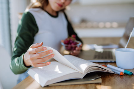 Young woman having distance education in her apartment.の写真素材