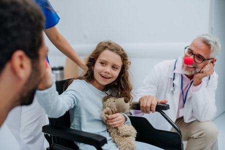 Happy doctors with clown red noses taking care about little girl.の写真素材