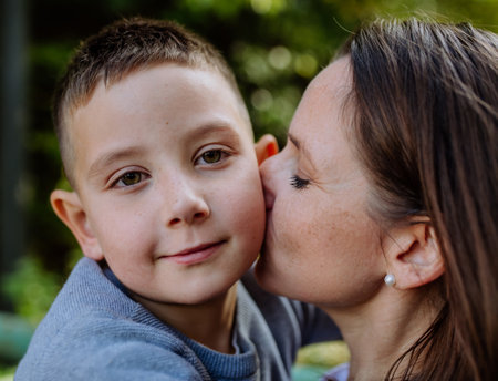 Portrait of mother with her son in forest.の写真素材