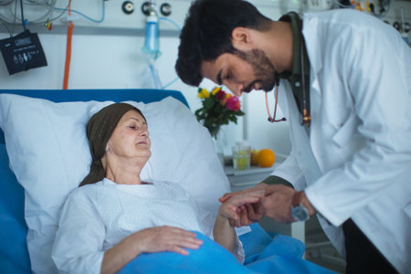 Young middle eastern doctor examining patient with cancer in hospital.の写真素材