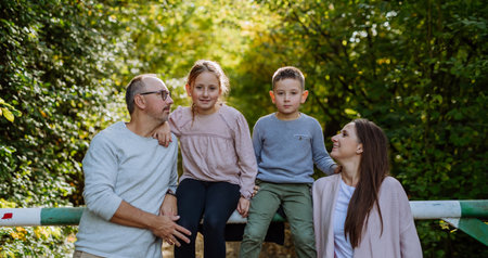 Portrait of happy family with kids in a forest.