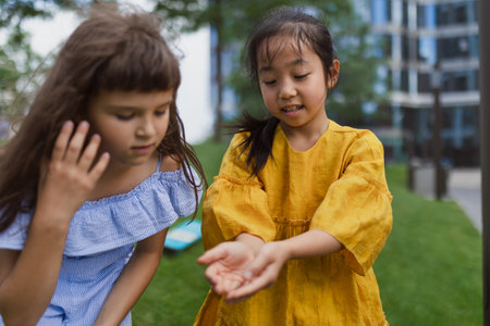 Happy friends playing and talking together in city park, during summer day.の写真素材