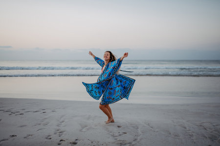 Young woman enjoying time at sea, dancing.の写真素材