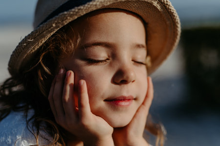 Portrait of little girl with closed eyes, at sea.の写真素材