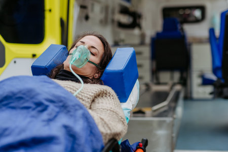 Close-up of woman patient in ambulance vehicle after serious accident.の写真素材