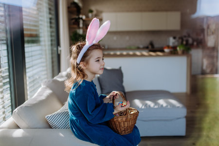 Portrait of little girl holding basket with easter eggs.