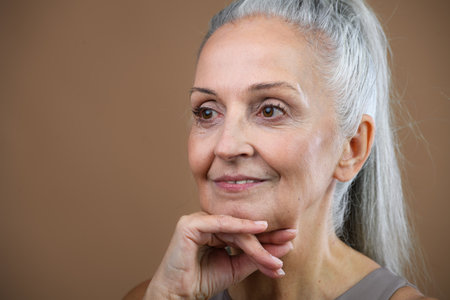 Portrait of smiling senior woman in studio.
