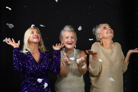 Portrait of happy senior friends with glass of wine, celebrating concept.の写真素材