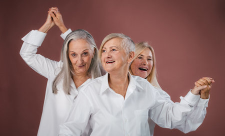 Portrait of three happy senior friends in studio.の写真素材