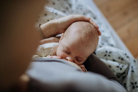 Close-up of mother brestfeeding her little newborn baby.の写真素材